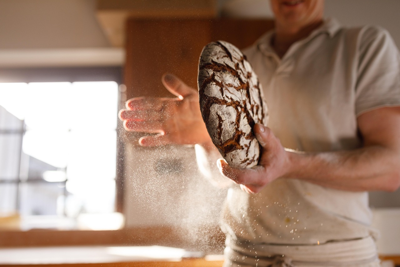 Pane appena sfornato con crosta dorata e croccante, evidenziando l'importanza del vapore nel forno.